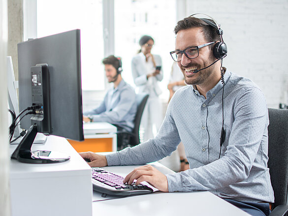 Guy in call, on pc, smiling, phone call, meeting, office,